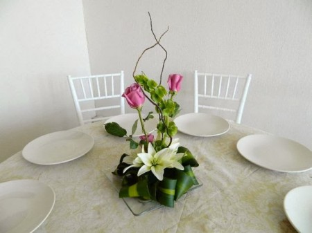 centro de mesa con rosas &amp; lilis, base de cristal  $90
